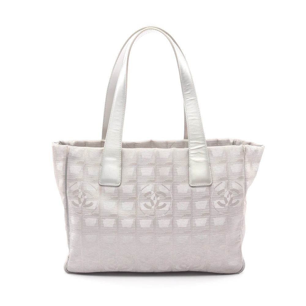 Chanel New Travel Line PM Gray: New Travel Line PM tote in gray silver nylon canvas and leather with silver hardware. Includes guarantee card and serial seal. Size 29 x 21 x 12 cm.