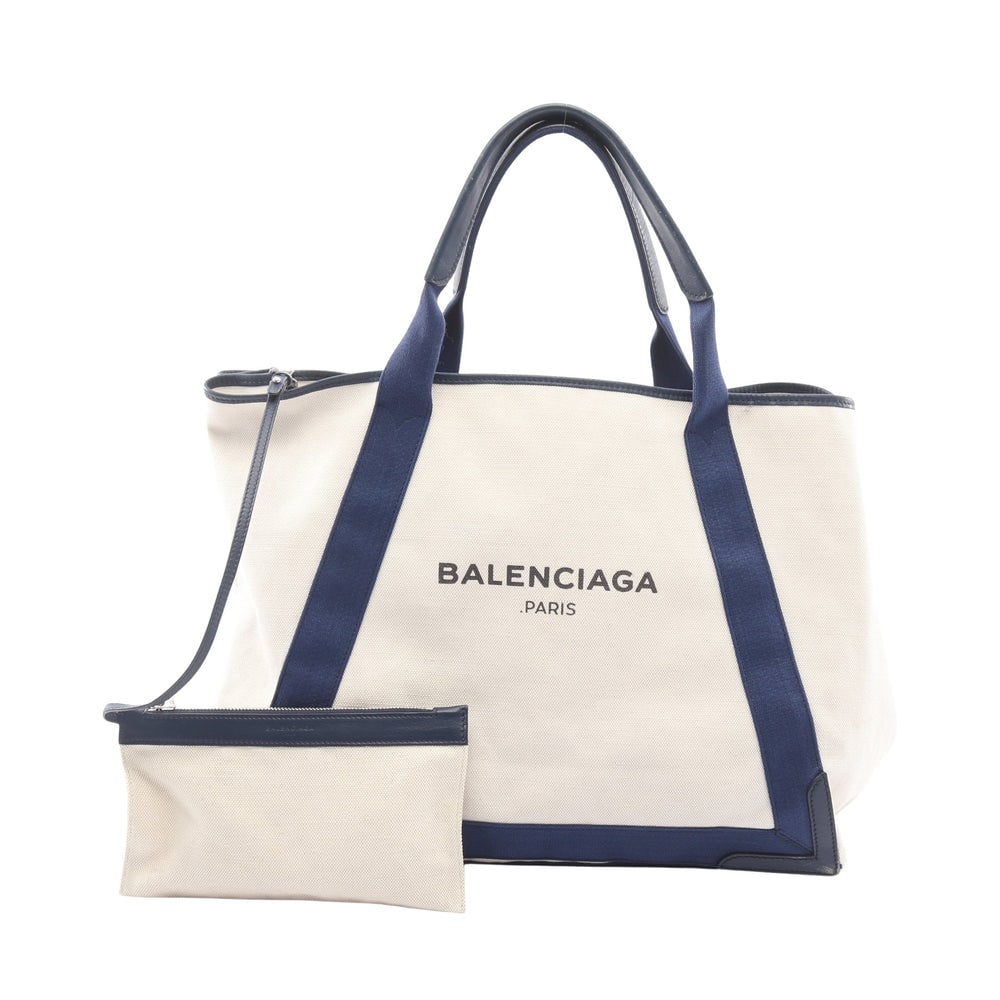 Balenciaga Navy Cabas M White Navy: Navy Cabas M 2 way tote in white and navy canvas and leather. Includes pouch. Size 42 x 33 x 20 cm. Handle 49 cm.