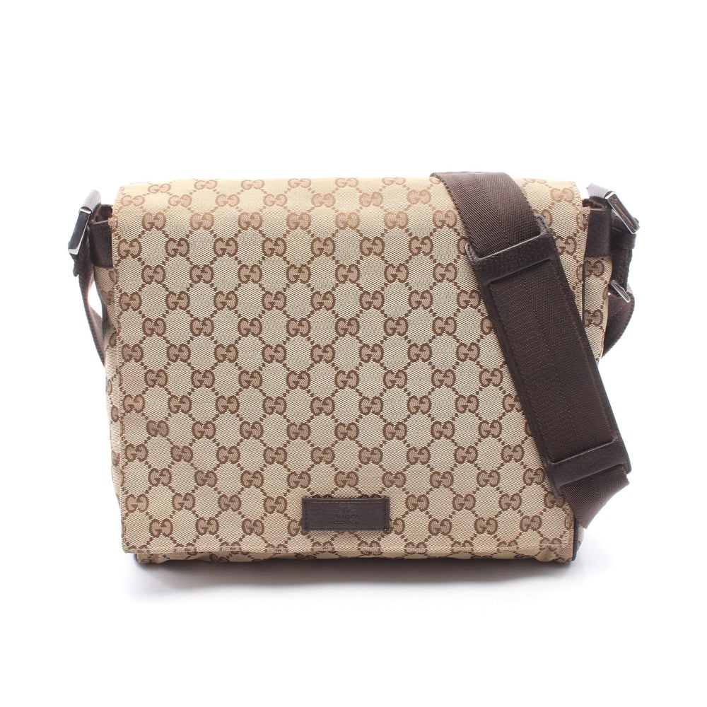 Gucci GG Canvas Shoulder Beige Brown: GG canvas shoulder bag in beige, brown, and dark brown. Size 31 x 26 x 8 cm. Strap 87 to 146 cm.