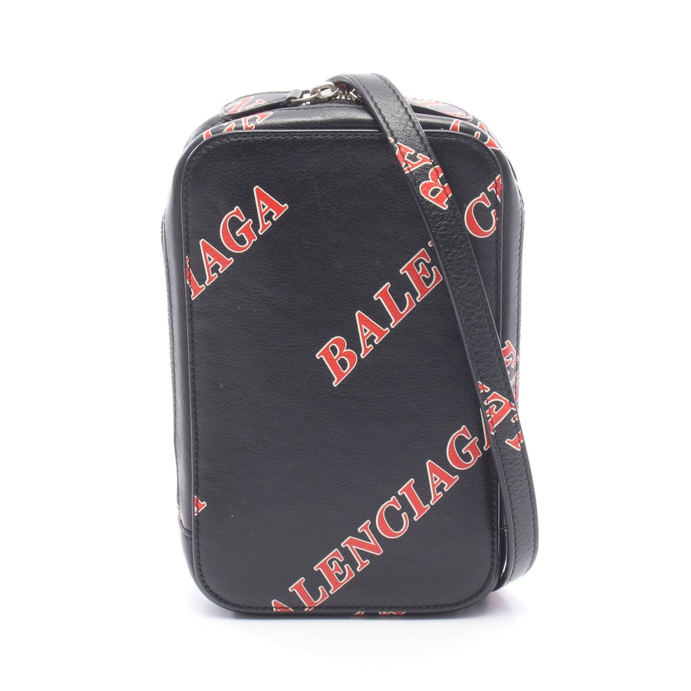 Balenciaga Cash Zip Phone Holder: Cash Zip phone holder shoulder bag in black, red, and white leather. Size 10.5 x 17 x 3 cm.