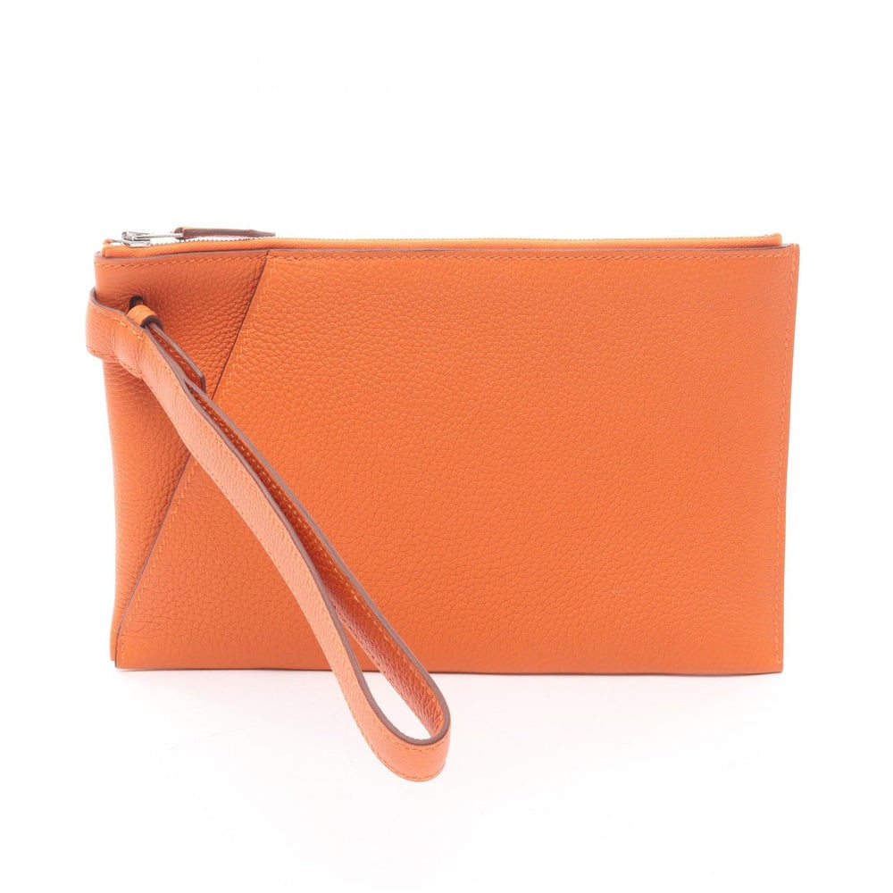 Hermes Vertige 24 Clutch Orange: Vertige 24 clutch in orange Togo leather with silver-tone hardware. Includes hand strap. Size 24 x 15 x 0.5 cm.