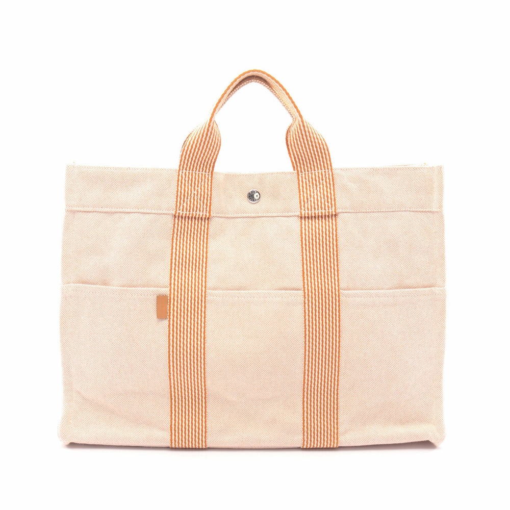 Hermes New Fool Toe MM Orange: New Fool Toe MM tote in light orange and yellow brown canvas with silver-tone hardware. Size 42 x 30 x 10 cm. Handle 27 cm.