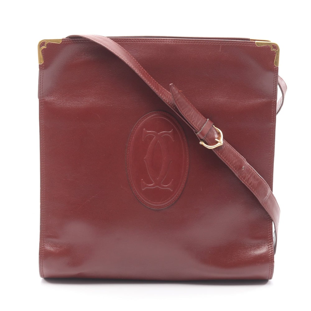 Cartier Must Line Shoulder Bordeaux: Must line shoulder bag in bordeaux leather. Size 25 x 25.5 x 6.5 cm. Strap 82 to 94 cm.
