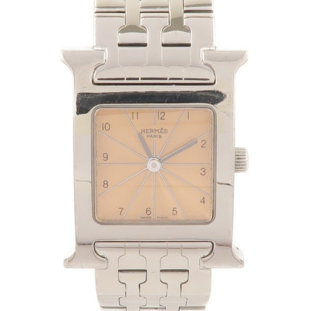 Hermes H Watch HH1.210 Quartz Bronze: Quartz H Watch HH1.210 in stainless steel with gold and pink tone. Case 30x21mm. Max wrist 15.5cm. Band width 14-16mm.