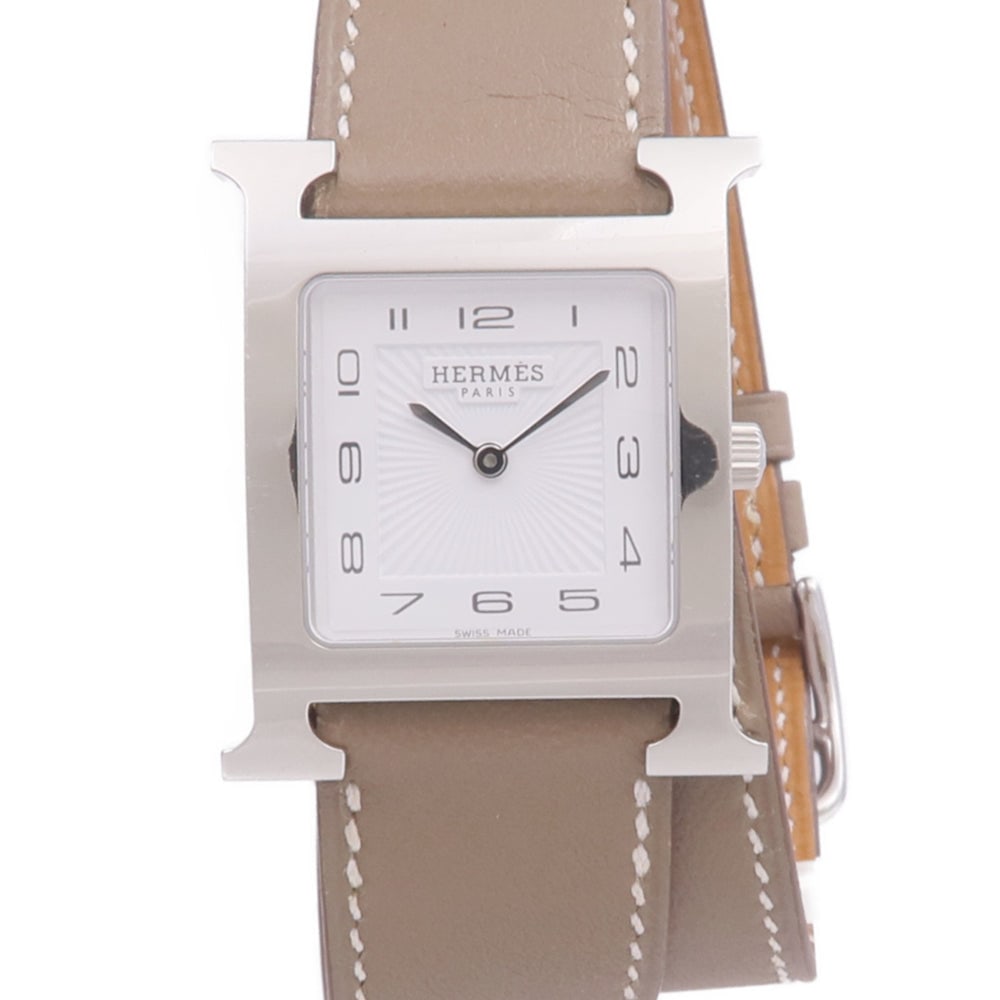 Hermes H Watch HH1.510 Quartz White: Quartz H Watch HH1.510 in stainless steel with leather belt, white dial and Etoupe tone. Case 34.9x29.9mm, wrist 14.5-17cm, band 15-20mm.