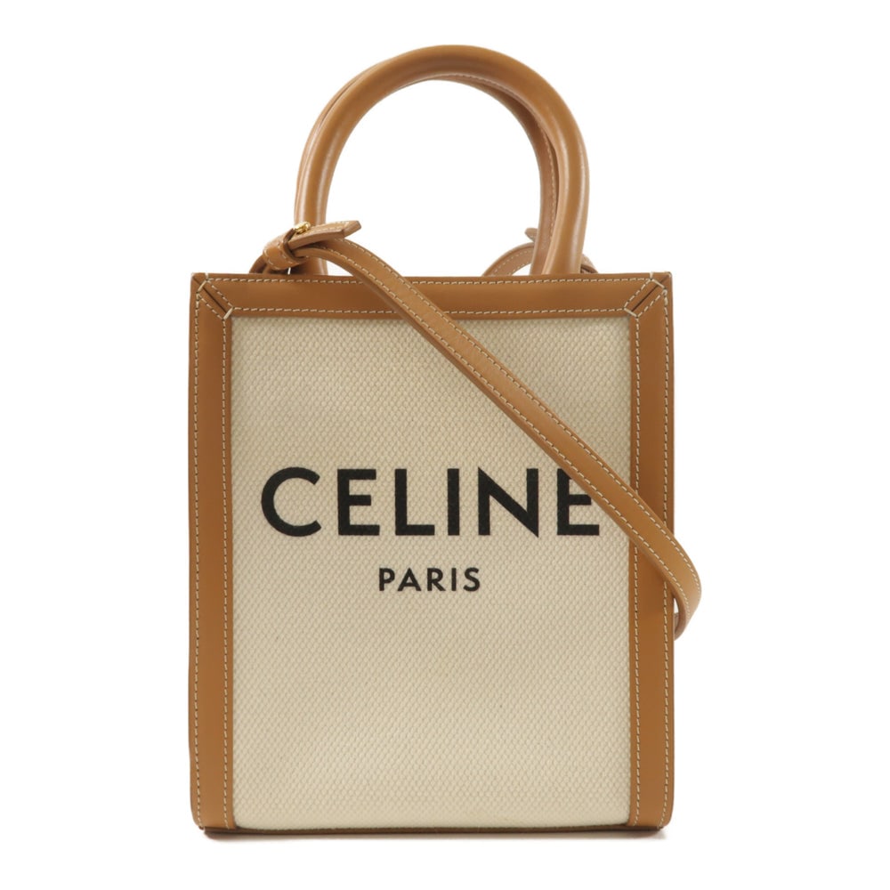 Celine Mini Vertical Cabas Brown: Mini Vertical Cabas 2 way shoulder bag in brown and white canvas and calfskin. Includes storage bags. Size 17 x 20 x 6 cm.