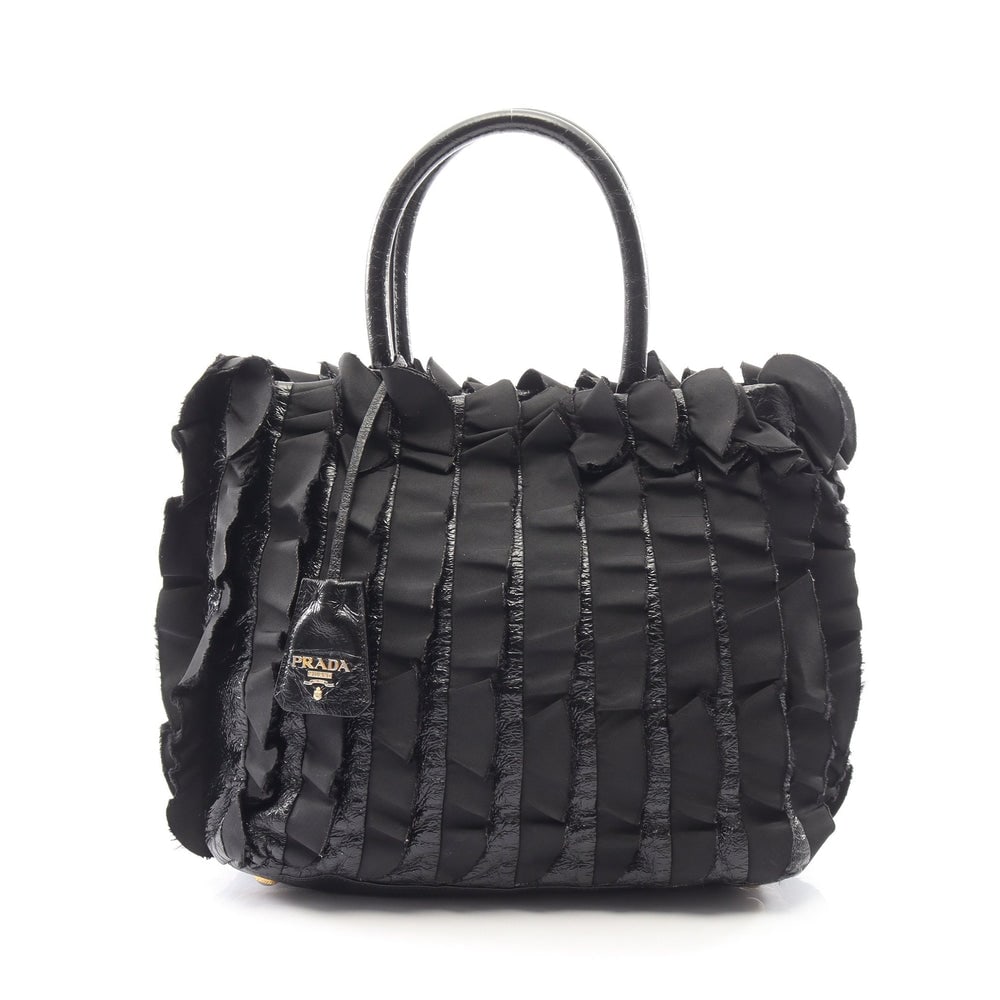 Prada Frill Handbag Black: Frill handbag in black nylon and patent leather. Includes crochet with key ring. Size 28 x 25 x 14 cm.