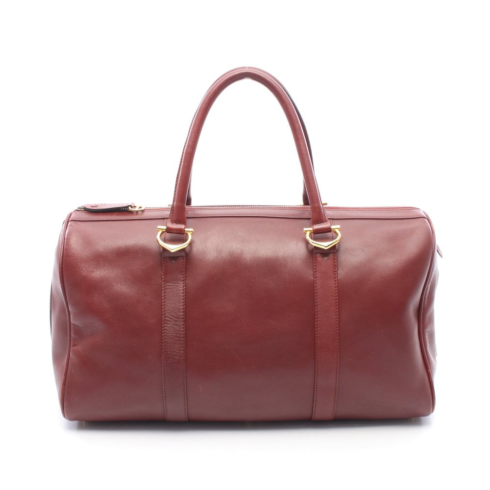 Cartier Must Line Boston Bordeaux: Must line travel boston bag in bordeaux leather. Size 44 x 23 x 20 cm. Handle 50 cm.