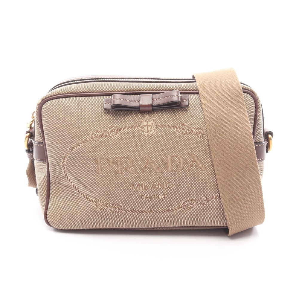 Prada Logo Jacquard Shoulder Beige: Logo Jacquard shoulder bag 1BH089 in beige and dark brown canvas and leather. Size 22 x 15 x 8 cm.