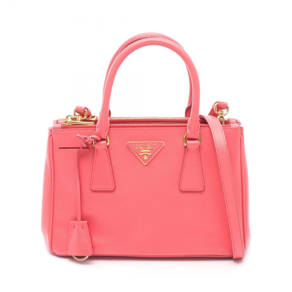 Prada Galleria 2 Way Pink: Saffiano Lux Galleria 2 way handbag BN2316 in pink saffiano leather. Includes crochet, guarantee card, and shoulder strap. Size 26.5 x 17 x 10.5 cm.