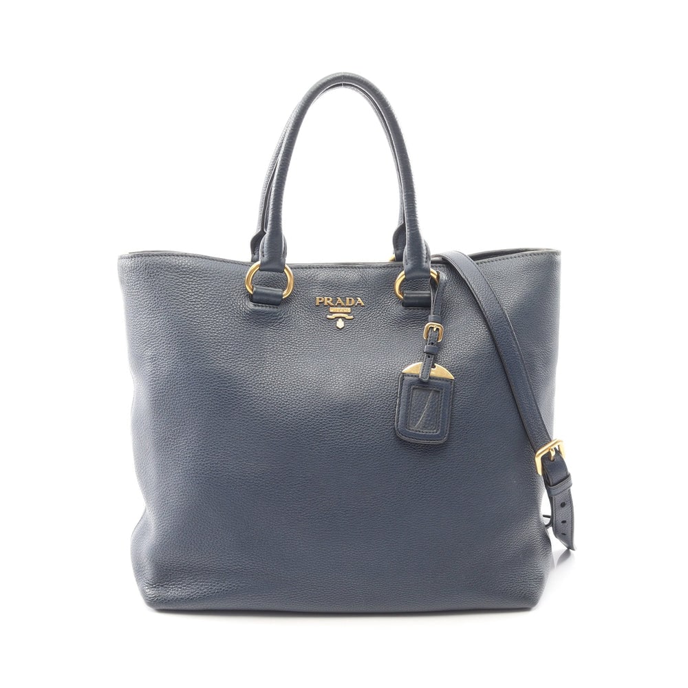 Prada Vitello Phenix 2 Way Navy: Vitello Phenix 2 way tote in navy leather. Includes shoulder strap and guarantee card. Size 33 x 31 x 14 cm.