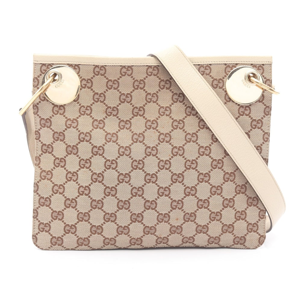 Gucci GG Canvas Shoulder Beige Brown: GG canvas shoulder bag in beige and brown. Size 28 x 23 x 7 cm. Strap 110 to 115 cm.