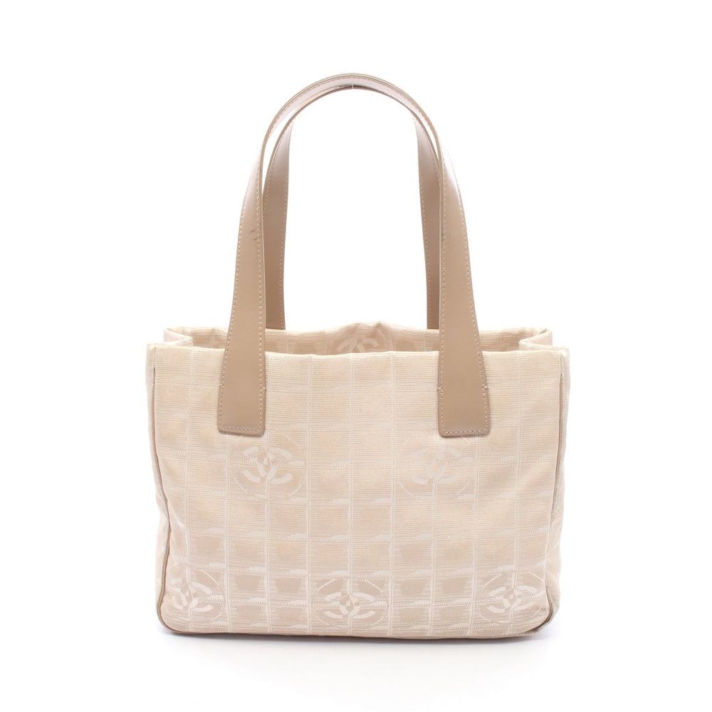 Chanel New Travel Line PM Beige: New Travel Line PM tote in beige nylon canvas and leather with gold-tone hardware. Serial seal included. Size 29 x 21 x 12 cm.