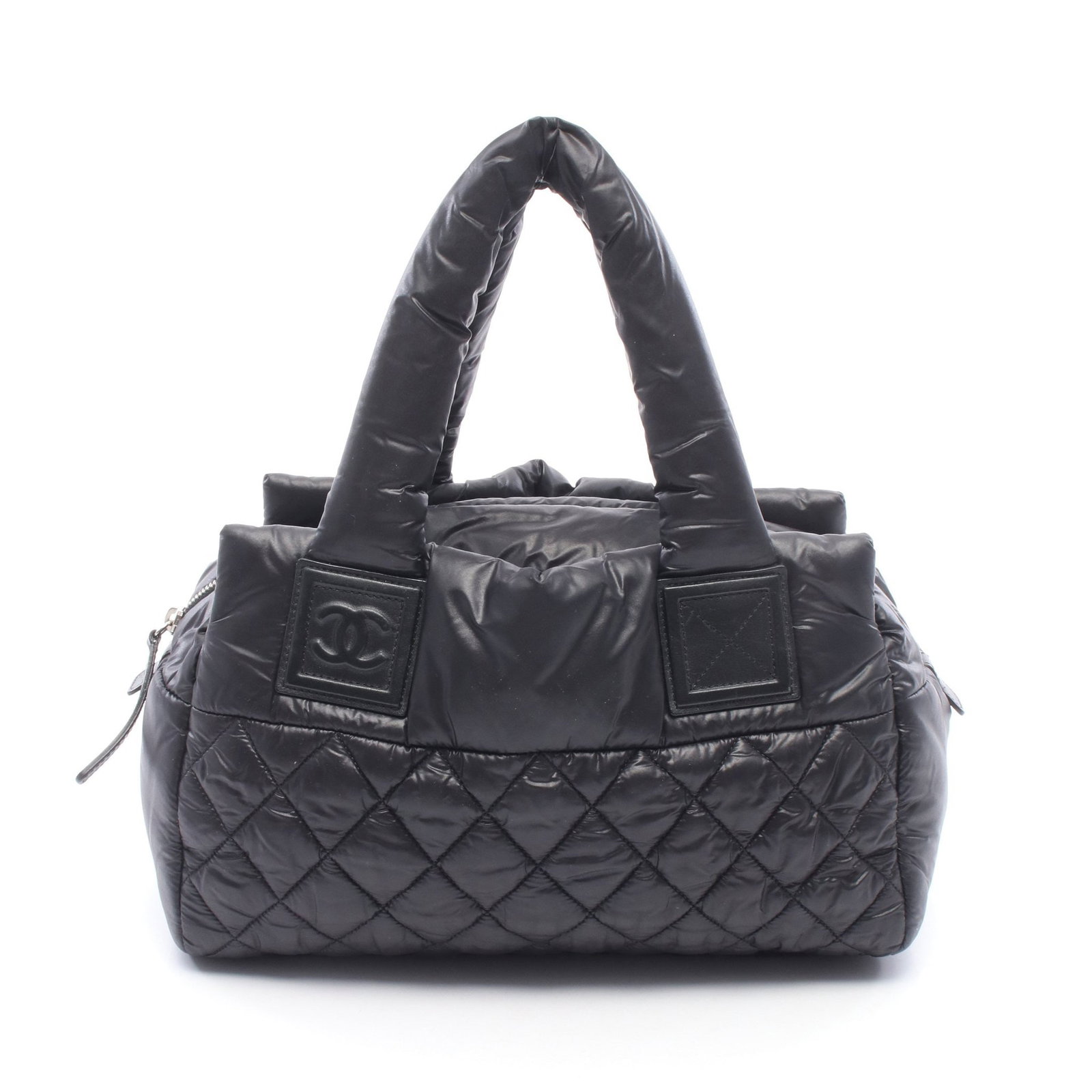 Chanel Coco Cocoon Handbag Black: Coco Cocoon handbag in black nylon and leather with silver hardware. Includes serial seal. Size 31 x 21 x 16 cm.