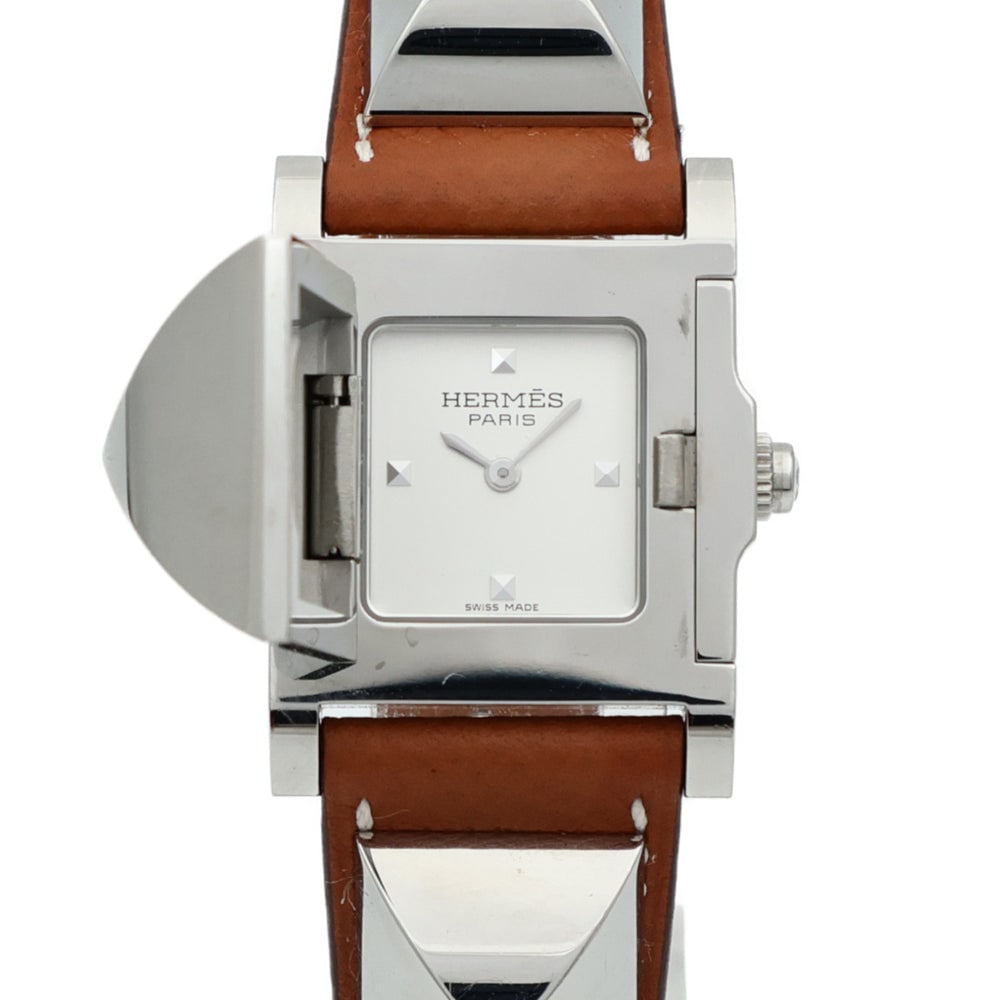 Hermes Medor ME3.210 Quartz Watch: White quartz Medor watch in stainless steel with leather belt. Includes storage box and guarantee. 32 x 23.08mm case, fits 13-16cm wrist.