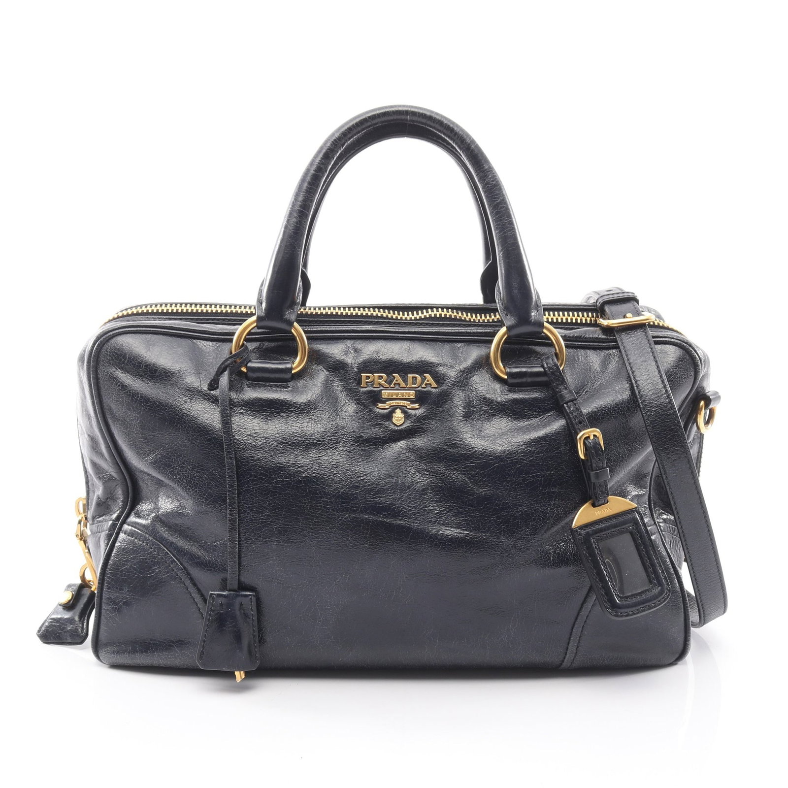 Prada Vitello Shine 2 Way Navy: Vitello Shine 2 way mini boston in navy leather. Includes shoulder strap, padlock, keys, name tag, and guarantee card. Size 34 x 23 x 15 cm.