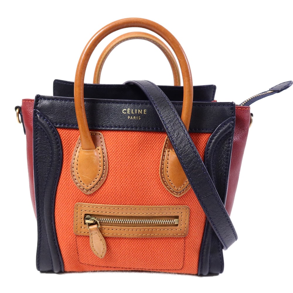 Celine Nano Luggage Red Canvas: Nano Luggage 2 way shoulder bag in red calfskin and canvas. Includes storage bags and shoulder strap. Size 20 x 18 x 10 cm.