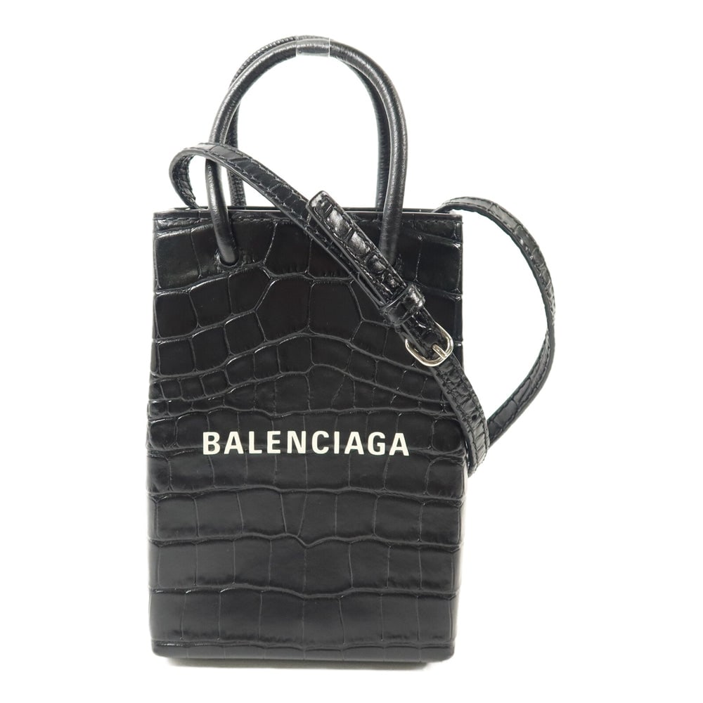Balenciaga Mini Shopping Holder: Mini Shopping phone holder 2 way shoulder bag in black calfskin. Includes storage bags. Size 12.5 x 17.5 x 4.5 cm.