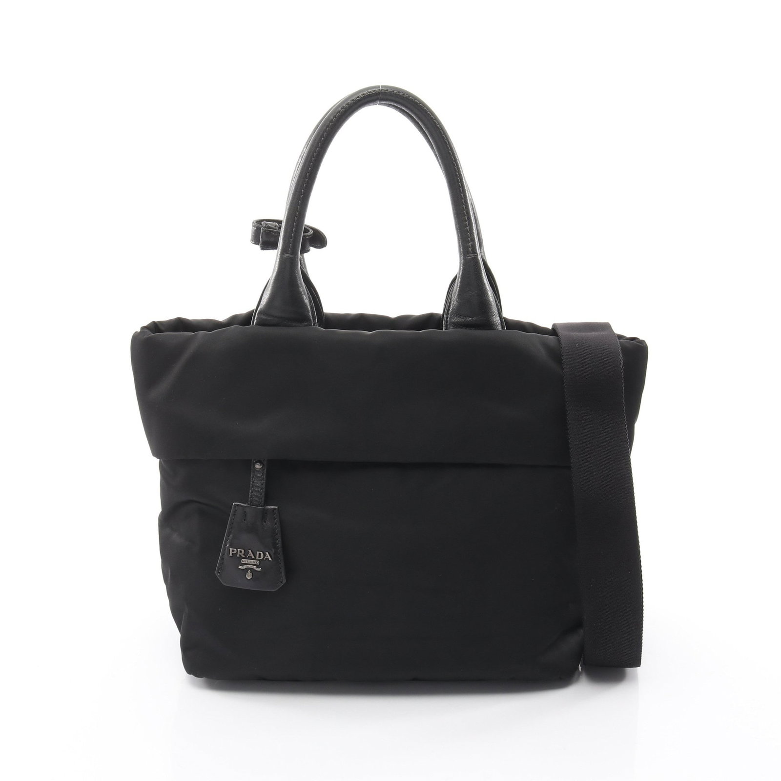 Prada 2Way Handbag Black: Black 2 way handbag in nylon and leather; includes shoulder strap, crochet with key ring, and poignet; 27 x 24 x 17 cm.