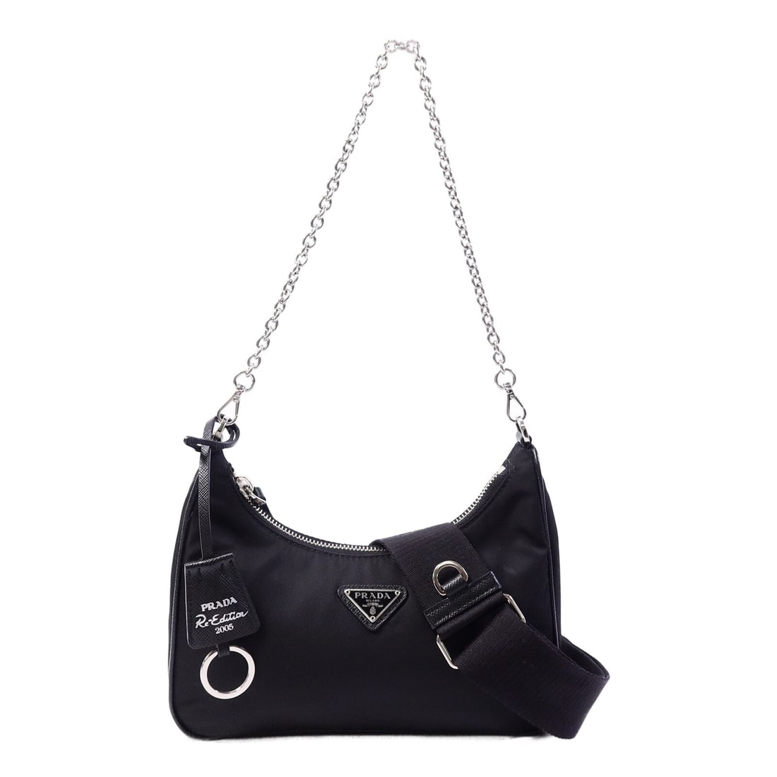Prada Re-Edition 2005 Black: Re-Edition 2005 chain shoulder bag 1BH204 in black nylon with silver hardware; includes storage bags, guarantee, shoulder strap, and clochette; 22 x 16 x 6 cm.