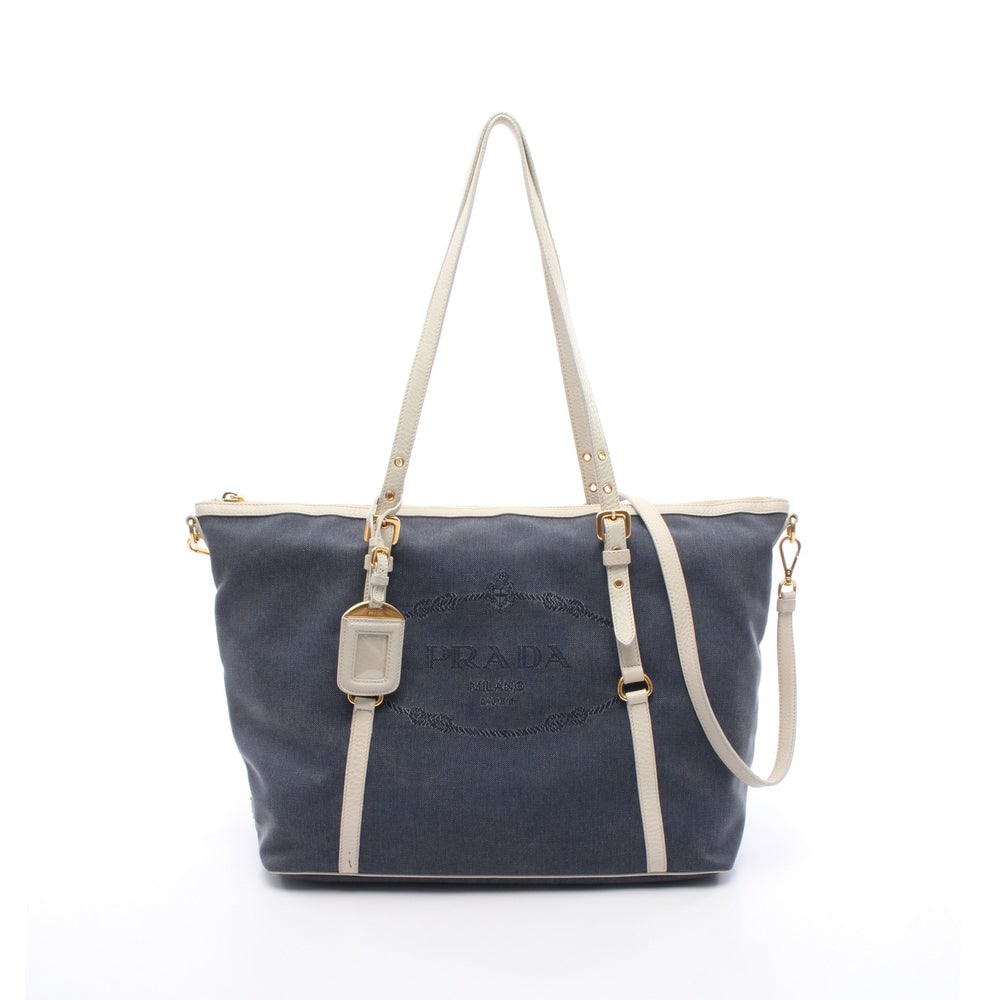 Prada Logo Jacquard 2WAY Tote: Authentic and authenticated Prada Logo Jacquard 2WAY shoulder tote in navy and white canvas leather. Model BR4253. Approx. 30H x 45/36.5W x 15D cm with 49-69 cm handle and 110-120 cm strap. Includes