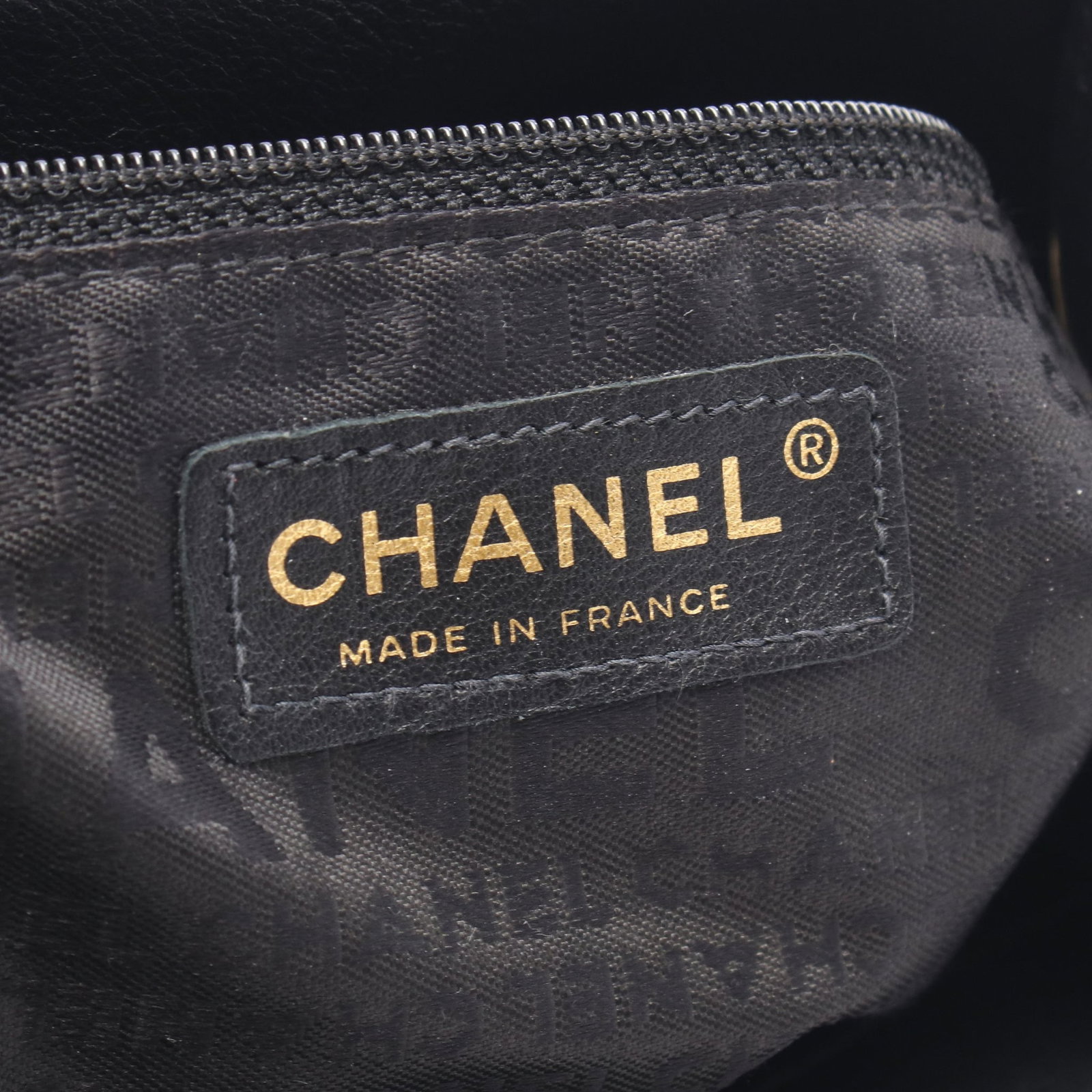 Chanel Camellia Lambskin Tote: Authentic and authenticated Chanel Logo Camellia shoulder tote bag in black and white lambskin with gold hardware. Approx. 26H x 21/24W x 12D cm with 55 cm strap. Includes serial seal.