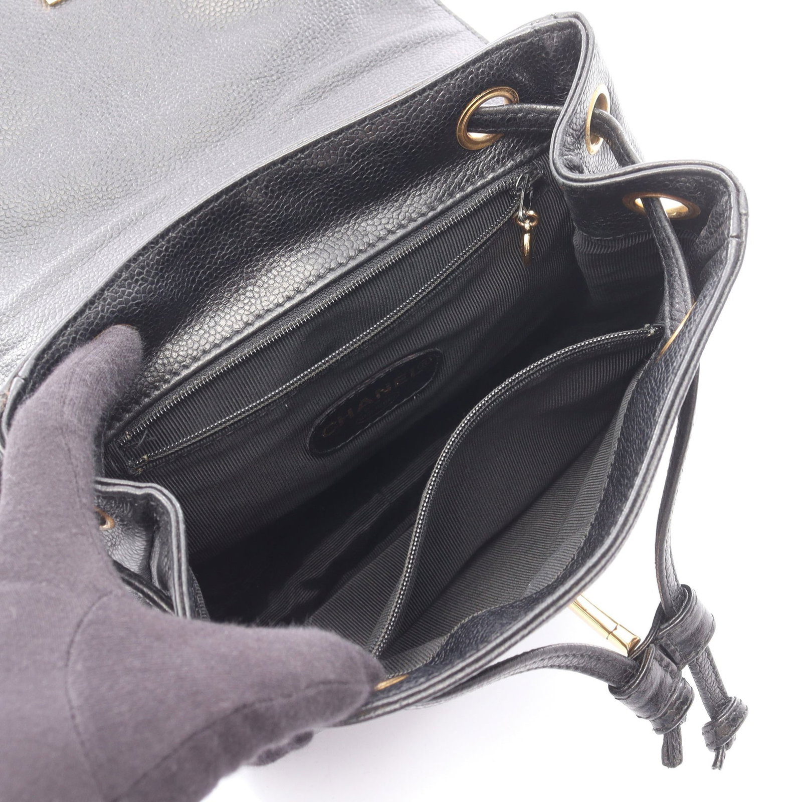 Chanel Triple Coco Backpack Black: Authentic and authenticated Chanel Triple Coco Mark backpack in black caviar skin with gold hardware. Approx. 26H x 21/20W x 9D cm with 76 cm strap. Includes serial seal.