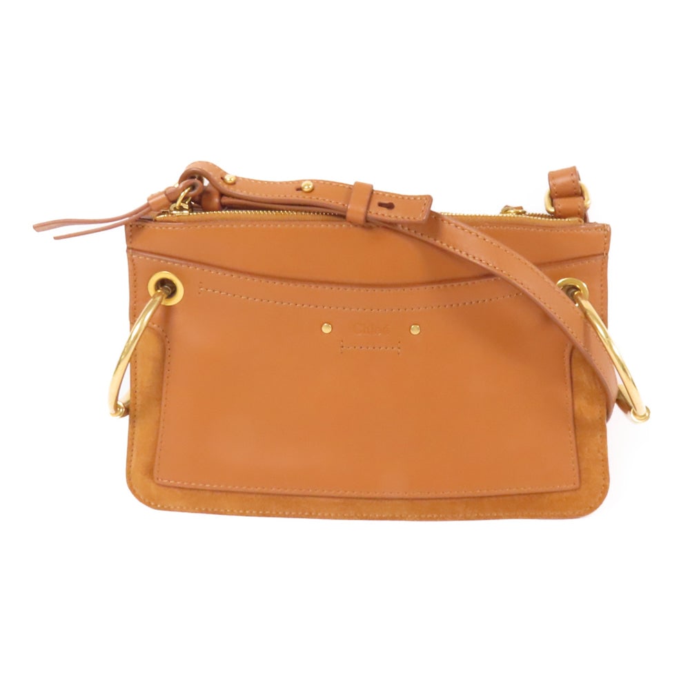 Chloe Mini Roy Shoulder Bag Brown: Authentic and authenticated Chloe Mini Roy shoulder bag in brown caramel suede calfskin. Product no. C14FBG. Approx. 25.5W x 16H x 3D cm with 105-115 cm strap. Includes storage bags.