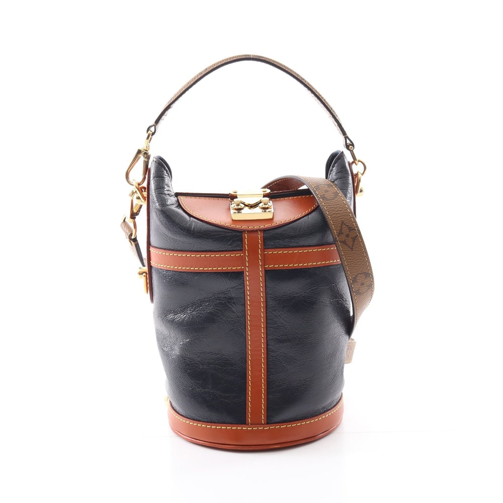 LV Duffel Monogram Reverse 2Way: Authentic and authenticated Louis Vuitton Duffel bag Monogram Reverse 2WAY handbag in navy light brown leather. Model M53842, product DU1119. Includes shoulder strap. Approx. 21.5 x 18/14 x 14 cm.