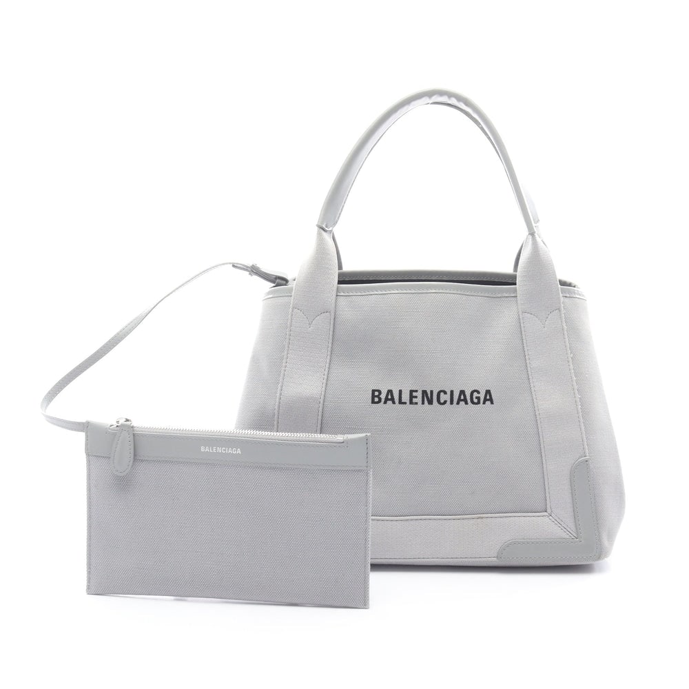 Balenciaga Navy Cabas S Gray: Balenciaga Navy Cabas S Handbag Tote Bag. Color: Gray. Material: Canvas Leather. Size: 32/30 X 22 X 18 Cm. Handle: 45 Cm. Includes: Pouch.