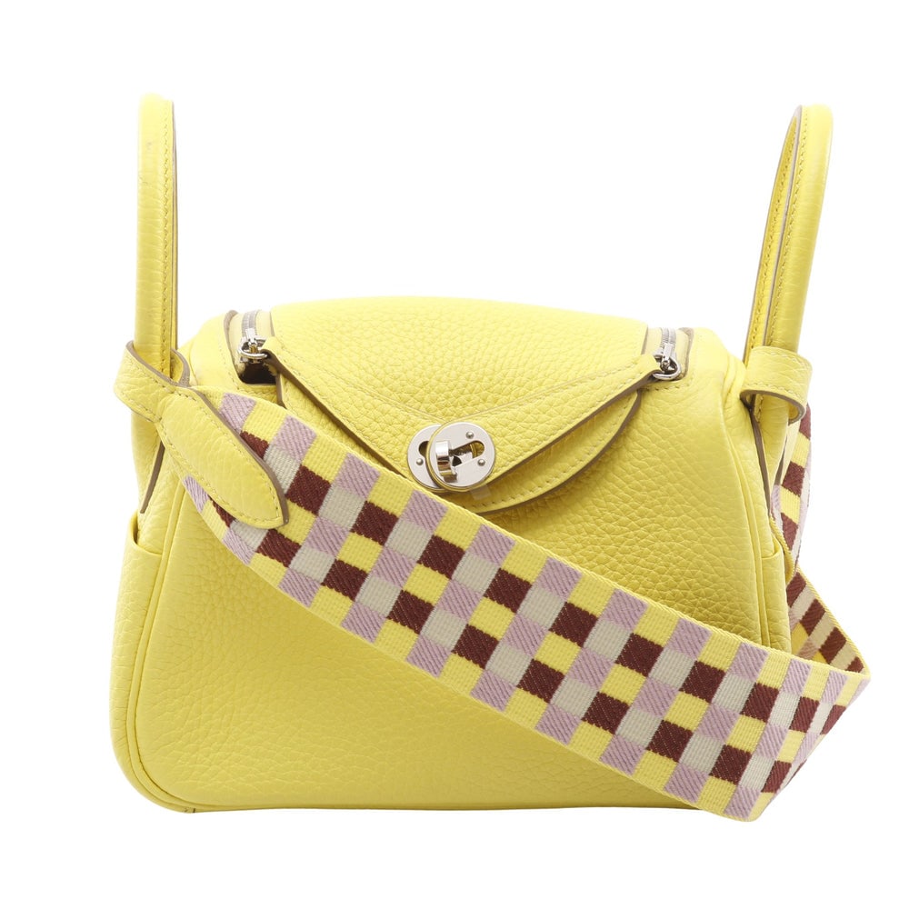 Hermes Lindy Mini Lime: Yellow clemence leather shoulder bag with silver hardware. 17.5 x 13 x 9 cm.