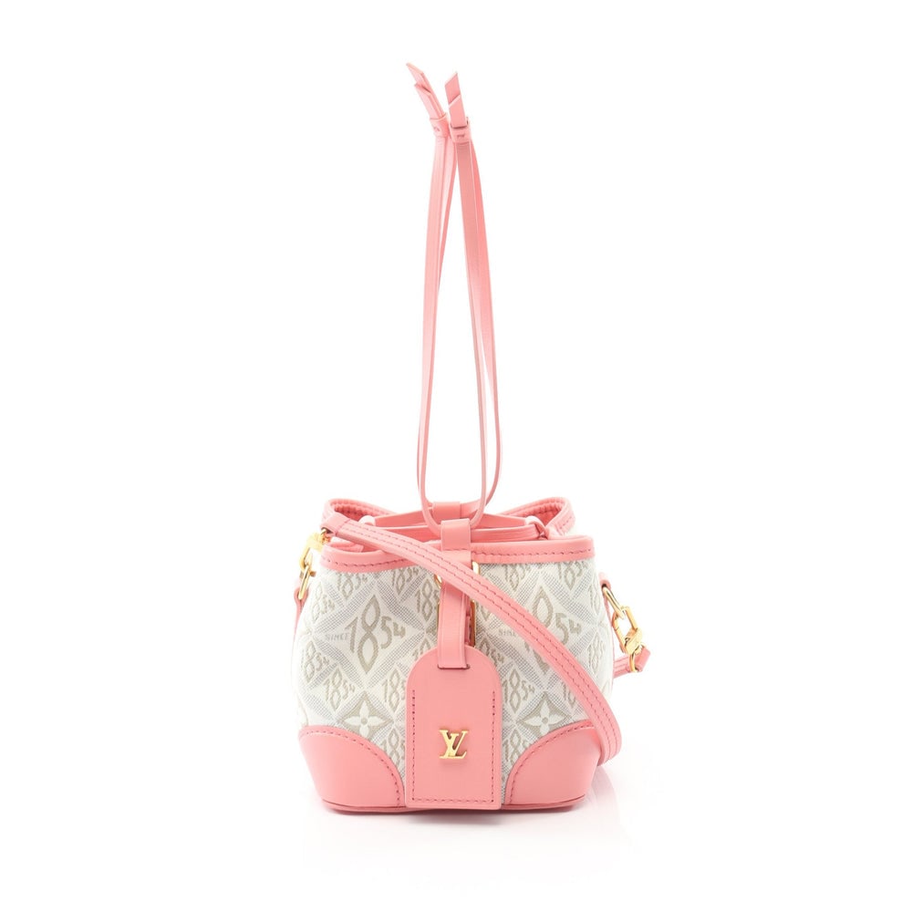 LV Noe Purse Since 1854 Pink: Off-white and pink canvas and leather Since 1854 Noe Purse 2-way handbag with shoulder strap and charm. Approx. 14 x 11.5 x 11.5 cm. Model M81112, RFID noted. Authentic and authenticated.