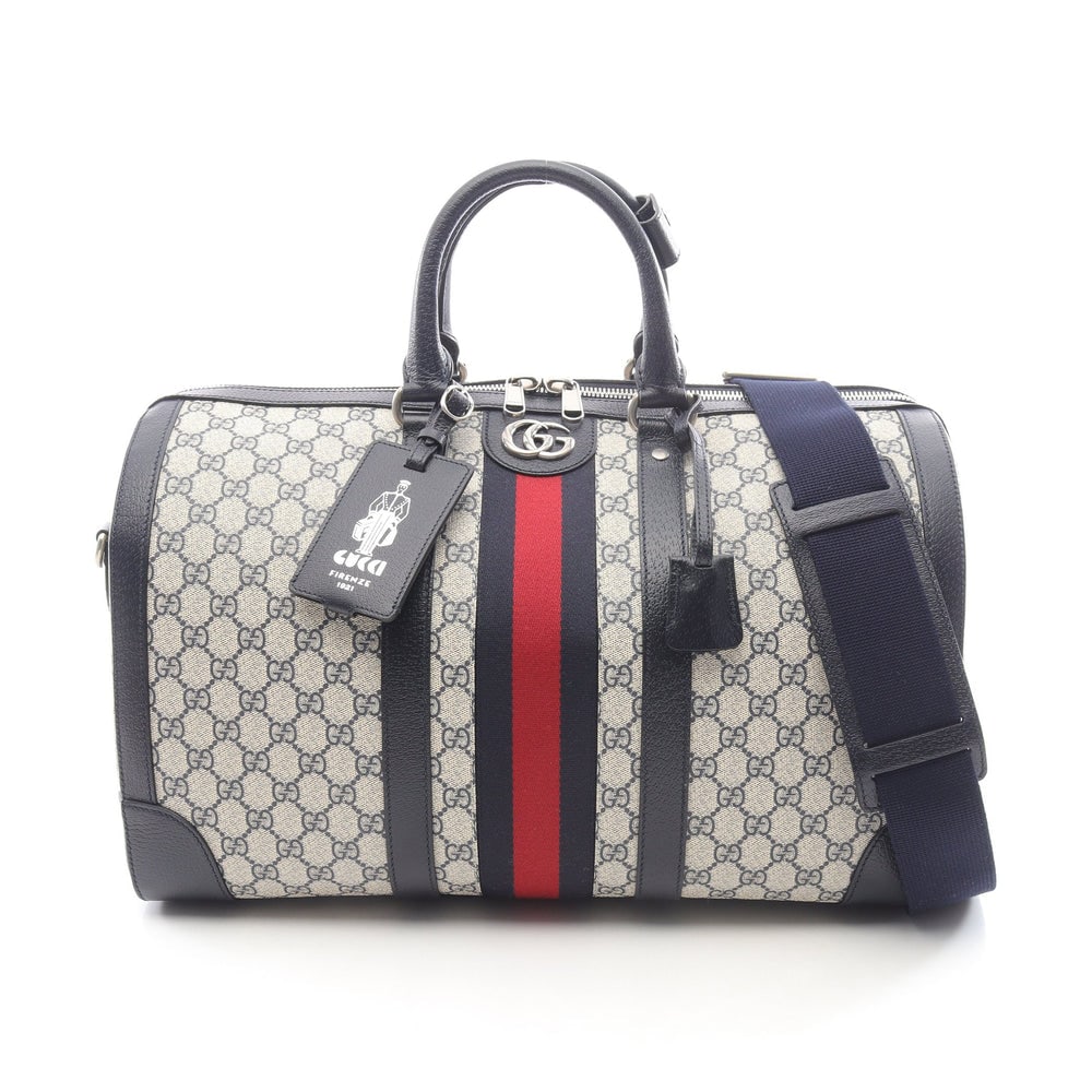 Gucci Medium Duffel Ivory Navy: Ivory and navy PVC leather GG Supreme medium duffel bag with padlock, 2 keys, crochet, shoulder strap, and name tag. Approx. 44 x 27 x 24 cm. Model 724642. Authentic and authenticated.