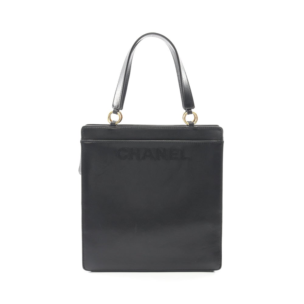 Chanel Lambskin Tote Black: Black lambskin Chanel tote handbag with logo and serial seal. Approx. 27 x 28 x 9 cm; handle 40 cm. Authentic and authenticated.