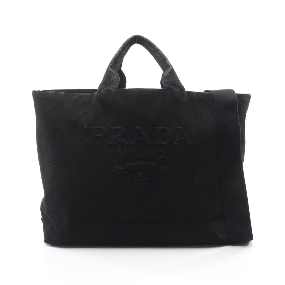 Prada Drill Canvas 2Way Tote: Authentic and authenticated Prada Drill 2WAY handbag tote in black canvas. Model 2VG081. Includes shoulder strap. Approx. 34 x 54/42 x 15 cm, strap 81-142 cm, handle 35 cm.