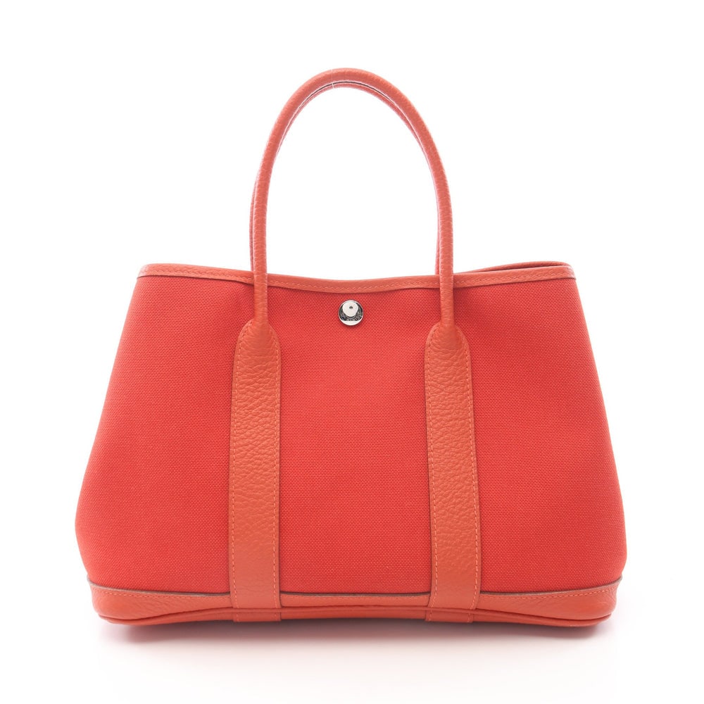 Hermes Garden Party TPM Orange Red: Orange red Toile military and Vache country tote with silver hardware; H21 x W28/30 x D14 cm; handle 36 cm. Authentic and authenticated.