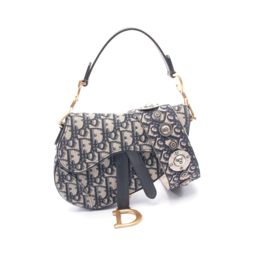 Dior Mini Saddle 2 Way: Ivory and navy Oblique jacquard canvas and leather mini saddle; includes optional shoulder strap; H13 x W19 x D6 cm. Authentic and authenticated.