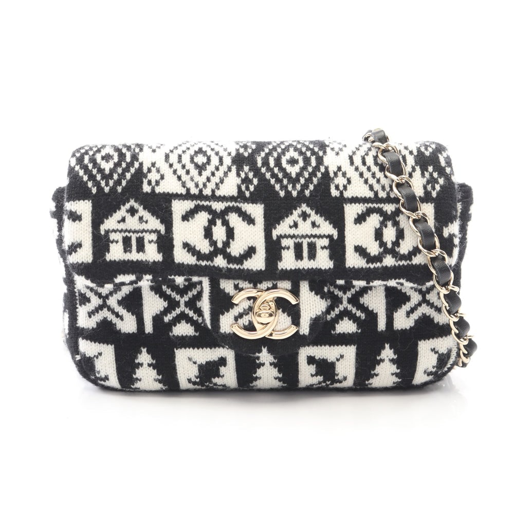 Chanel Coco Neige Chain Bag: Black and white wool chain shoulder bag with gold hardware. Includes guarantee card and serial seal. 19 x 13 x 4 cm.