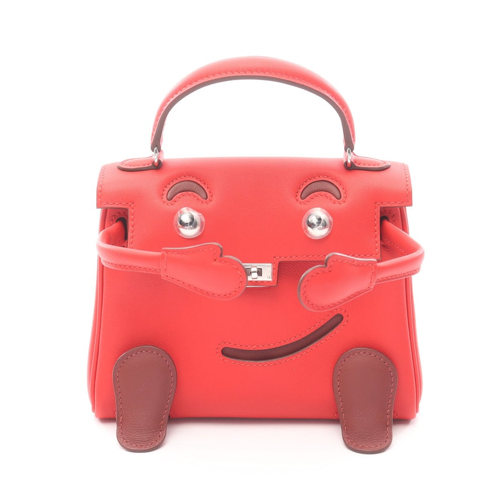 Hermes Kelly Doll Rouge: Red bordeaux veau Swift handbag with silver hardware. 16 x 13 x 7 cm.