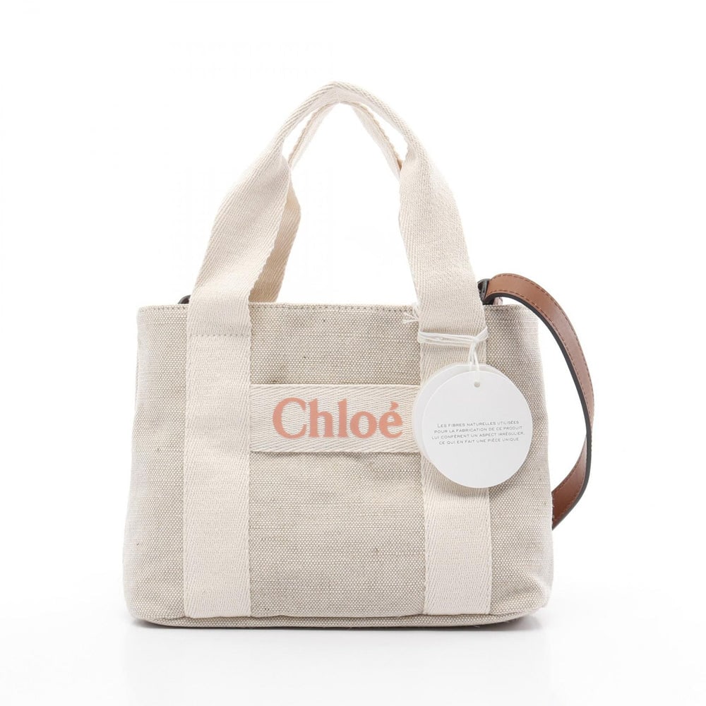 Chloe Kids 2Way Tote Beige: Chloe Kids 2Way Handbag Tote Bag. Color: Beige. Material: Canvas. Size: 25 X 20 X 7 Cm. Handle: 37 Cm. Strap: 93 Cm.