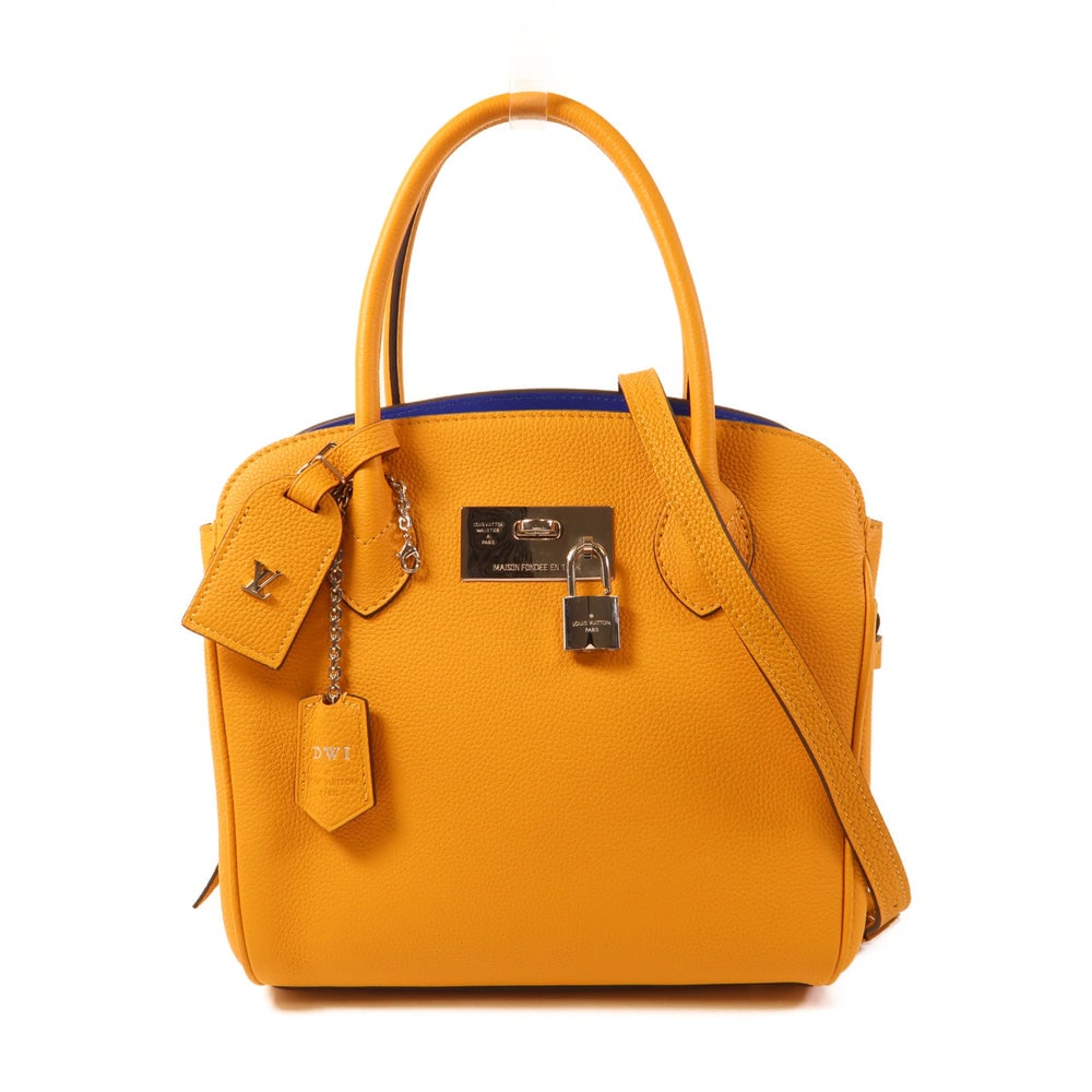 LV Milla PM Orange: Orange and yellow calfskin Milla PM 2-way shoulder bag with shoulder strap, clochette, key, padlock, and name tag. Approx. 23 x 23.5 x 15.5 cm. RFID. Authentic and authenticated.