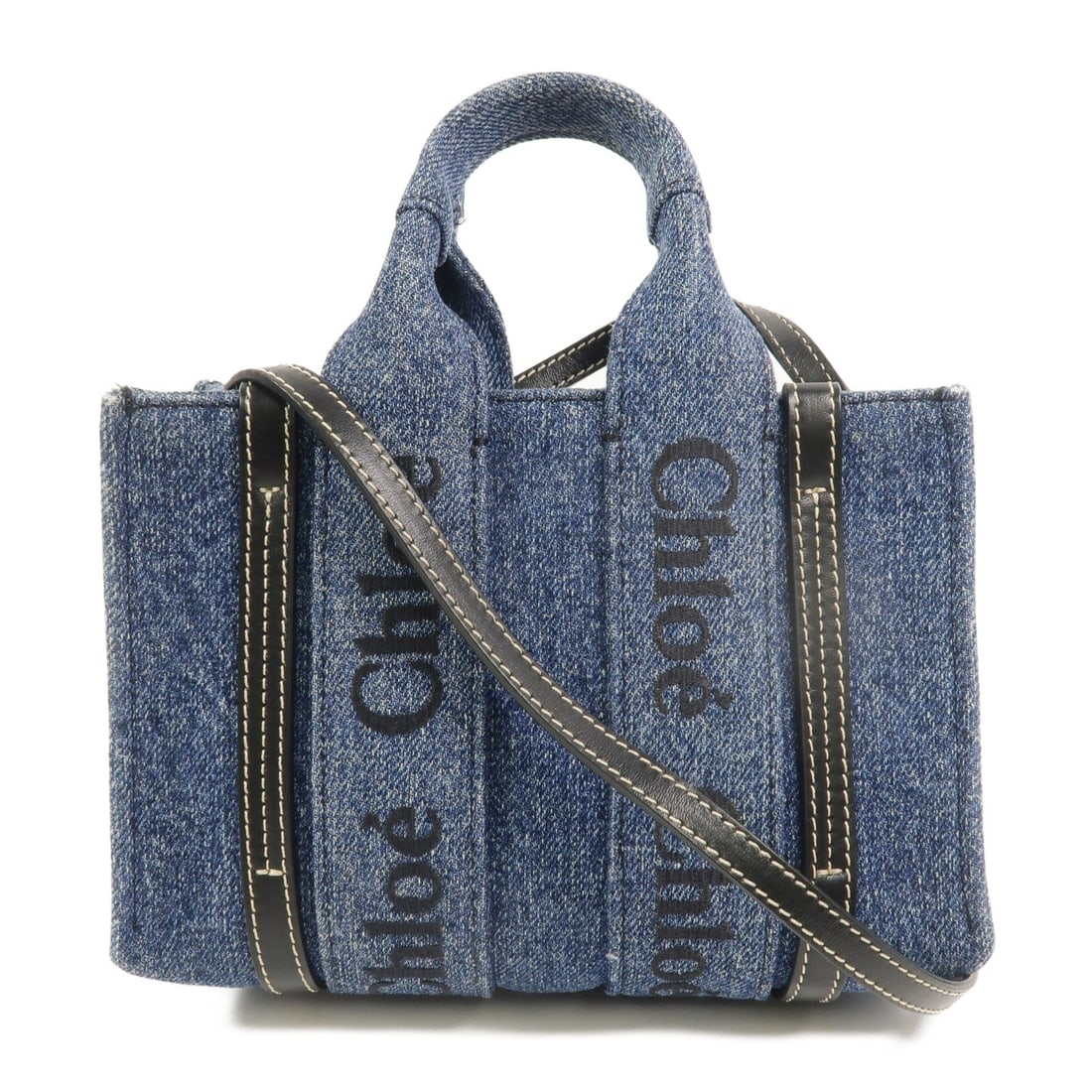 Chloe Woody Tote Mini Denim Blue: Authentic and authenticated Chloe Woody Tote Mini 2 Way shoulder bag in blue denim. Product no. 022310165. Approx. 20W x 14H x 7D cm with 21 cm handle and 108 cm strap. Includes storage bags.