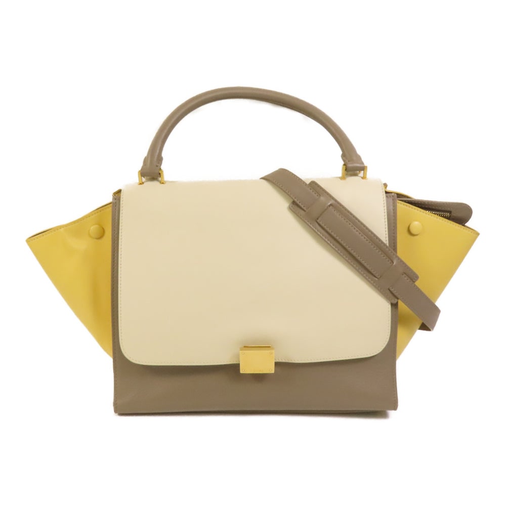 Celine Trapeze 2 Way White Yellow: Authentic and authenticated Celine Trapeze 2way shoulder bag in white and yellow calfskin. Product no. S-CU-1123. Approx. 30W x 24H x 17D cm with 30 cm handle and 78 cm strap. Includes shoulder strap.
