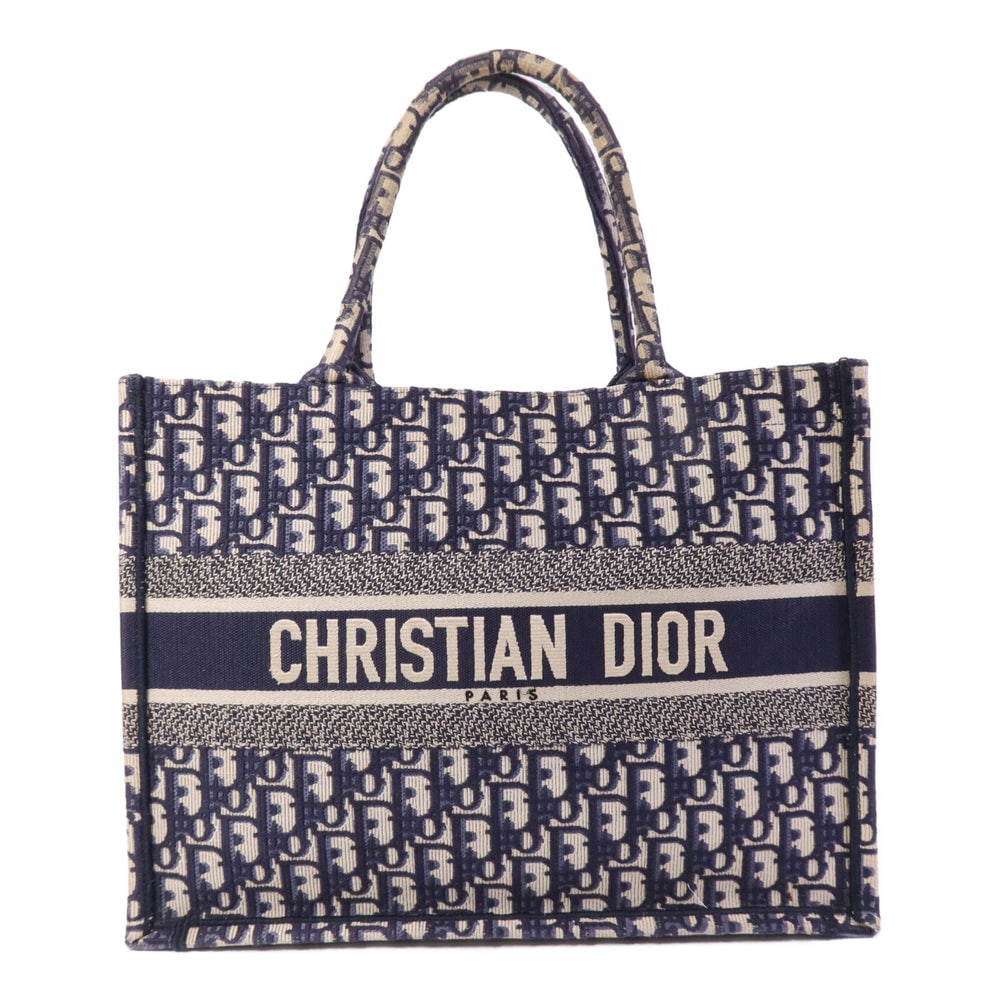 Dior Book Tote Medium Blue: Blue canvas Dior Book Tote Medium tote bag with storage bags. Approx. 36 x 27.5 x 16.5 cm; handle 41 cm. Product no. 50-MA-0210. Authentic and authenticated.