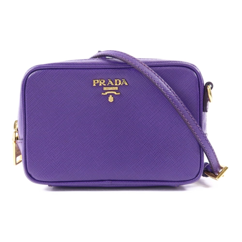 Prada Calfskin Pouch Shoulder Bag: Authentic and authenticated Prada pouch shoulder bag in purple calfskin. Product no. 37W. Approx. 15W x 10H x 5.5D cm with 118-140 cm strap. Includes storage box, guarantee, and shoulder strap.