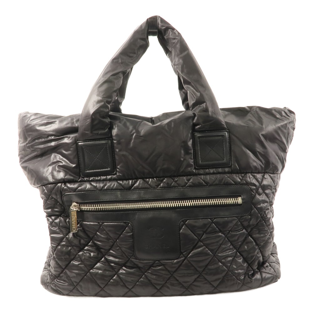 Chanel Coco Cocoon Tote Black: Coco Cocoon tote bag in black nylon with silver-tone hardware. Includes storage bags and hologram sticker. Size 47 x 33 x 14 cm.