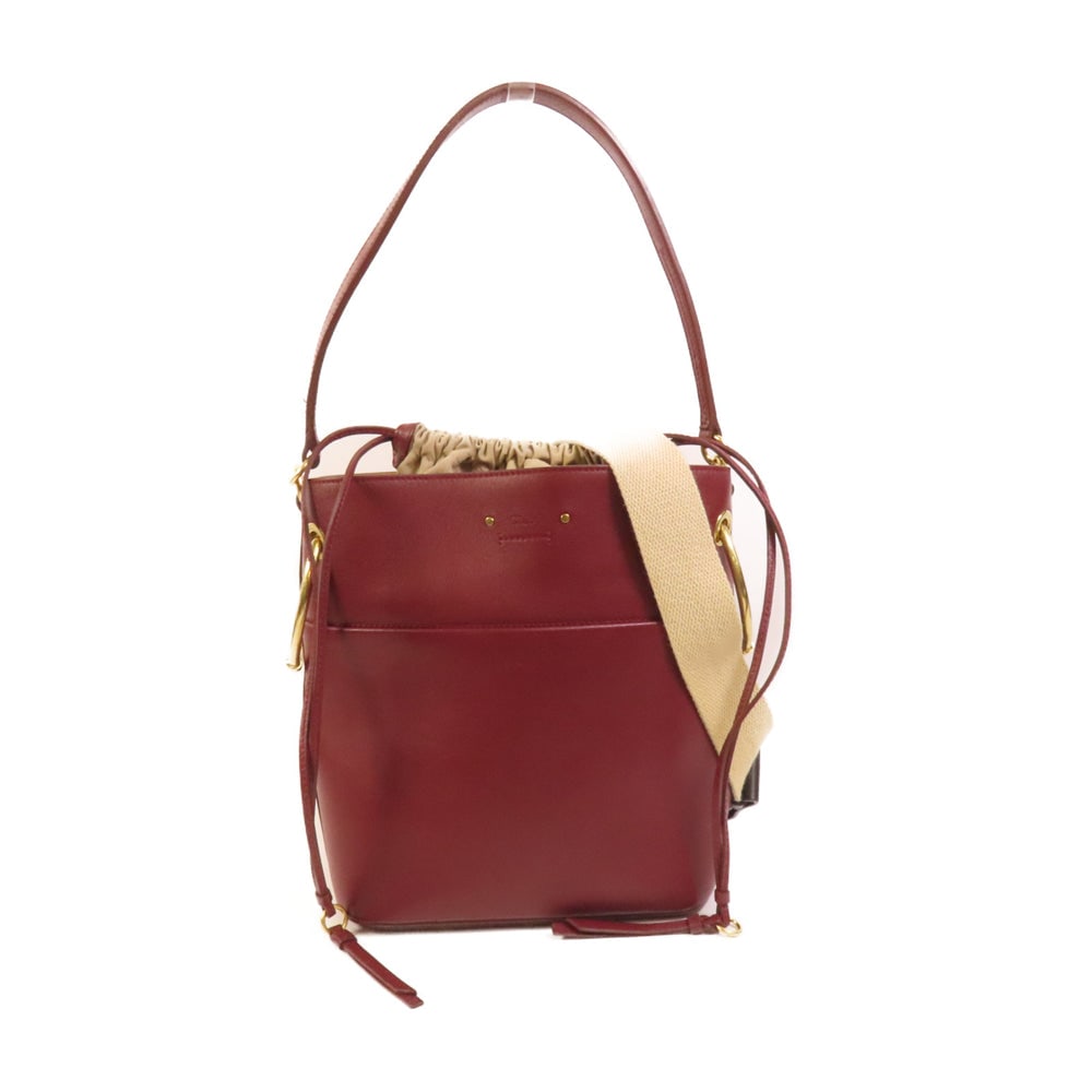 Chloe Roy 2 Way Shoulder Bag Red: Authentic and authenticated Chloe Roy 2 way shoulder bag in red calfskin. Product no. SN1015. Approx. 23W x 27H x 13D cm with 53 cm handle and 93-99 cm strap. Includes shoulder strap.