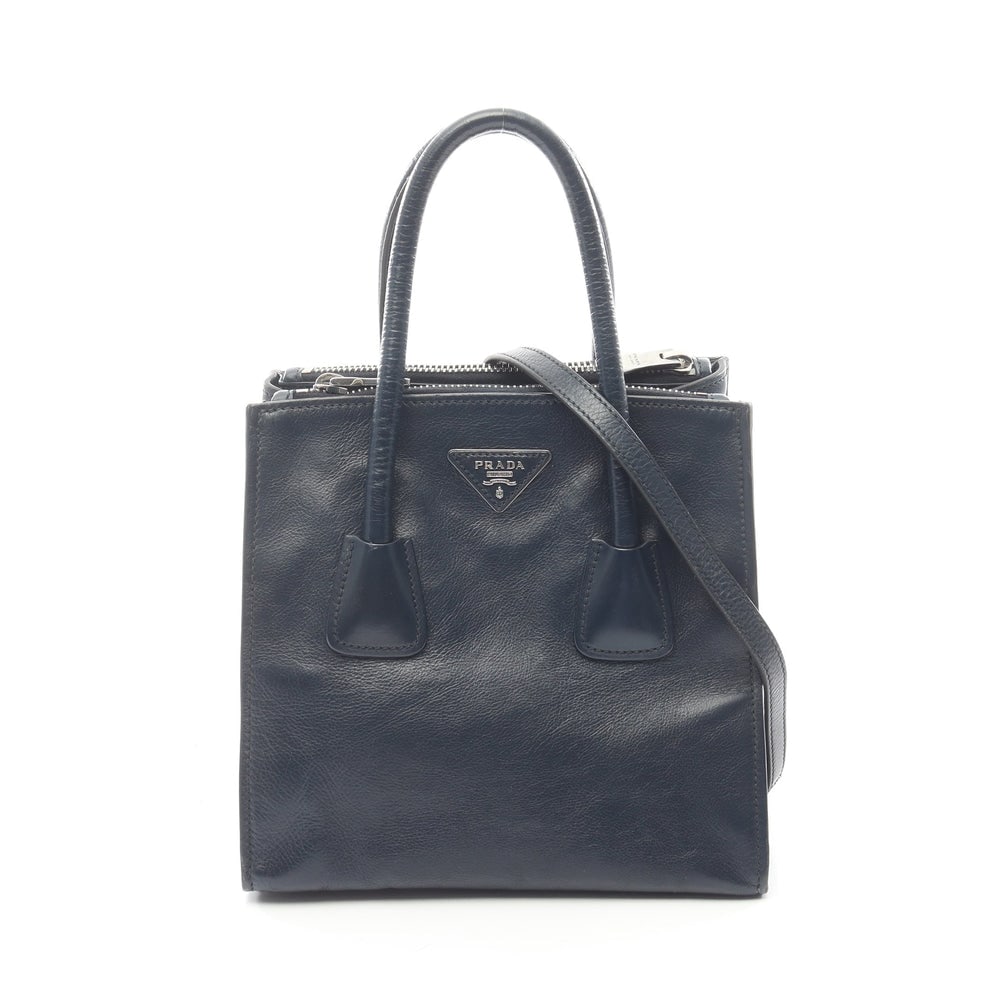 Prada Navy Leather 2WAY Handbag: Authentic and authenticated Prada 2WAY handbag in navy leather. Approx. 23H x 23/24W x 18D cm with 41 cm handle and 116-126 cm strap. Includes shoulder strap.