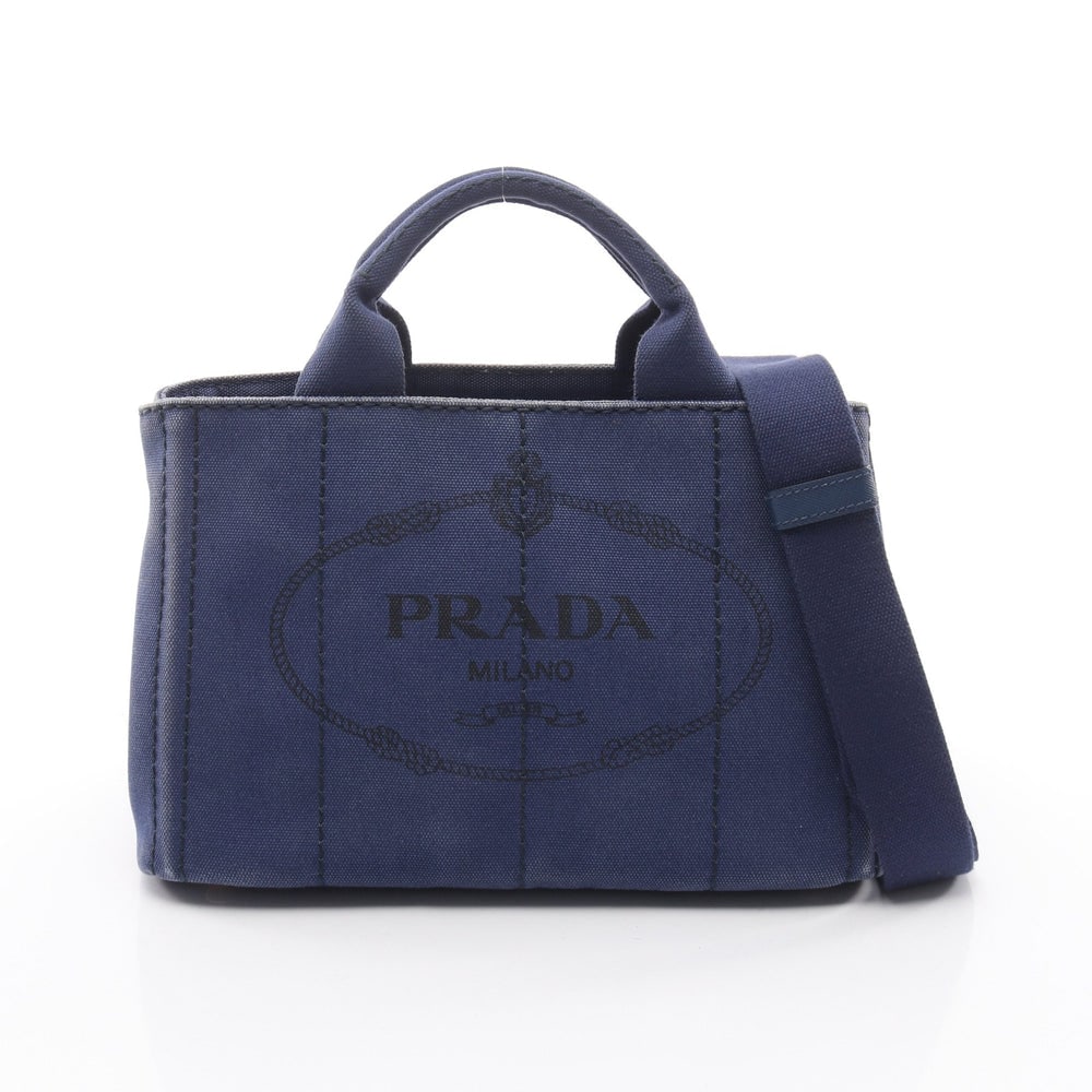 Prada Canapa Blue Canvas 2WAY Tote: Authentic and authenticated Prada Canapa 2WAY tote handbag in blue canvas. Model 1BG439. Approx. 19H x 29W x 14D cm with 32.5 cm handle and 74-133 cm strap. Includes shoulder strap.