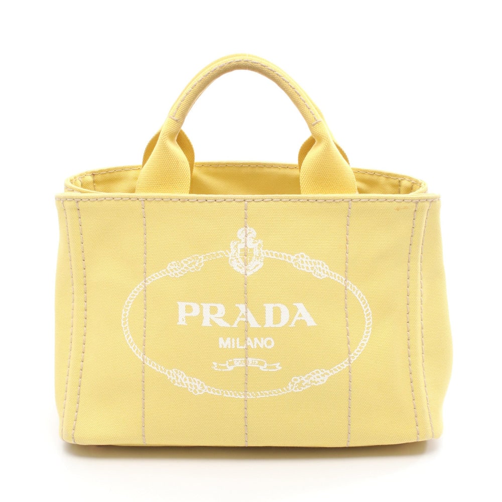 Prada Canapa Mini Canvas Tote Yellow: Authentic and authenticated Prada Canapa Mini tote handbag in yellow canvas. Model BN2439. Approx. 19H x 26/28W x 15D cm with 26 cm handle. No accessories listed.